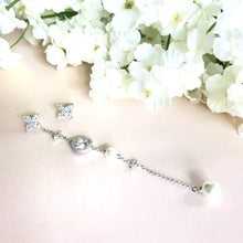 Crystal and pearl symbol asymmetric earrings
