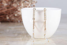 crystal paved chain-and-tassel earrings