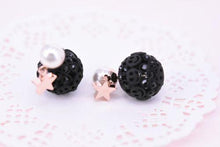 Black round studs with smiley face patterns